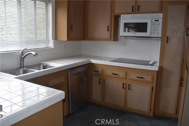 Kitchen with stainless steel dishwasher.