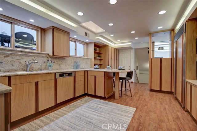 Another view of kitchen. Door at end to left accesses back yard. Stairs go down to garage.