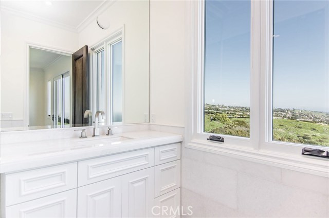 2nd bedroom with lush landscape and ocean view from ensuite bathroom