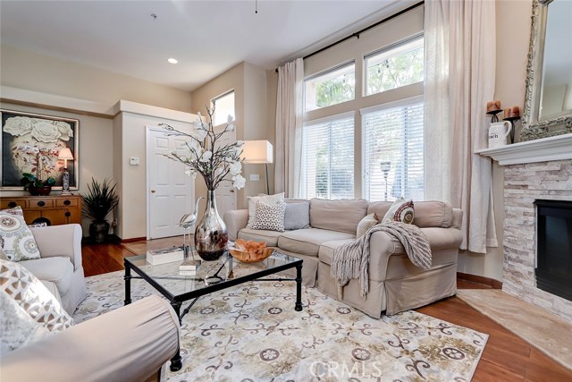 Front entry and great room area includes custom window treatment and stacked stone fireplace.