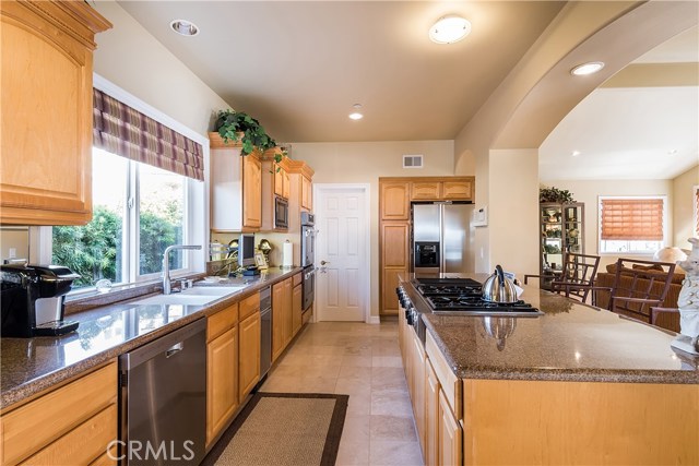 Self explanatory with view from breakfast area toward adjoining kitchen, center island, and open view toward family room.