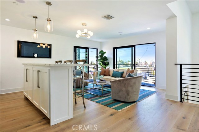 The Large Dual Sliding Doors, lead out the Wrap Around Balcony and the Stairway leading up to the Huge Rooftop Panoramic View Deck.