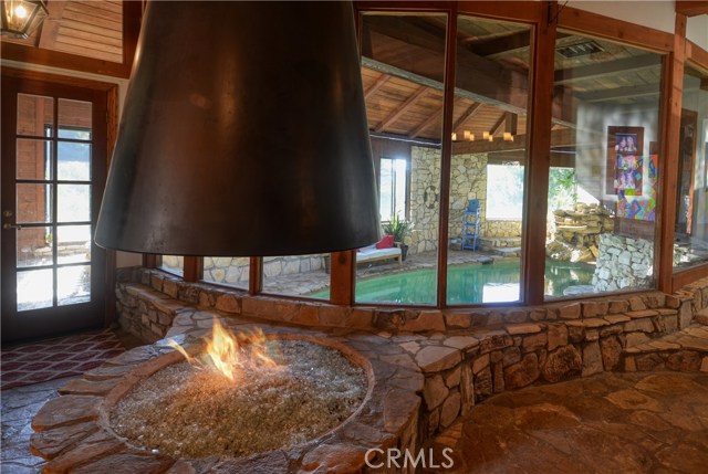 In addition to the brick fireplace, the Great Room features a dramatic firepit.