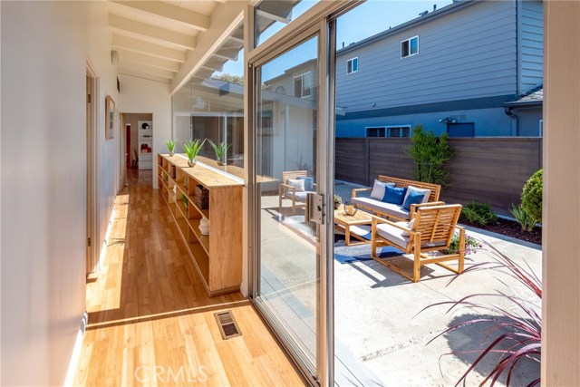 All bedrooms are off of this hallway. Built-in book case in blonde colored wood. Slider opens to patio.