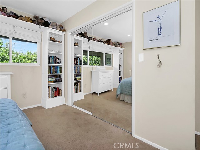 Secondary bedroom #1 with mirrored closet doors