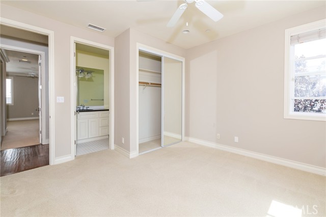 Front bedroom featuring en-suite bathroom and closet