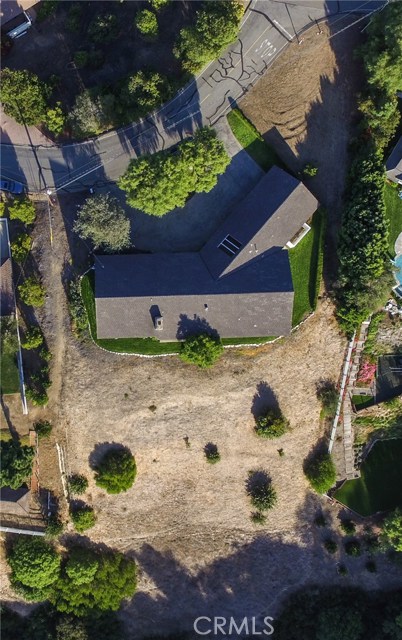 Aerial view showing home plus back, front and large side yard (top right corner).