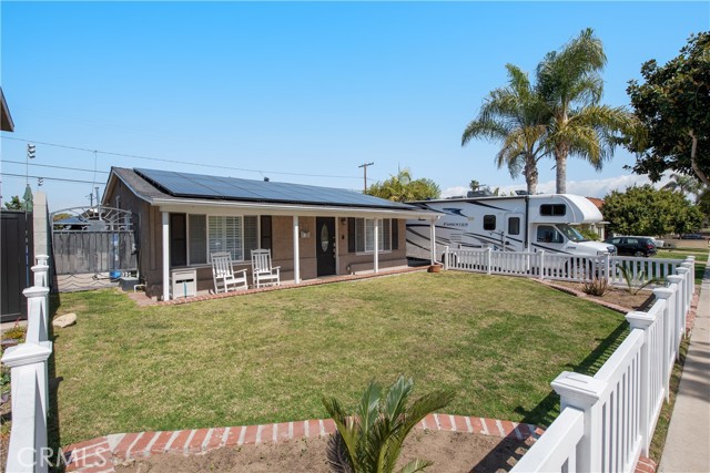 Charming single level home with great front yard, picket fence, porch and even RV parking!