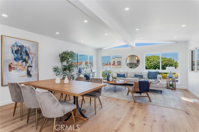 Beautiful white oak flooring throughout the home, seen in this open concept living area.