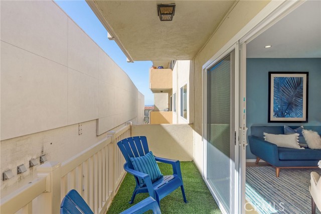 Balcony area lined with artificial turf and a peekaboo ocean view.