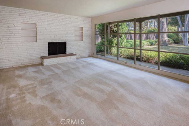 Living room with view to yard, built ins and fireplace