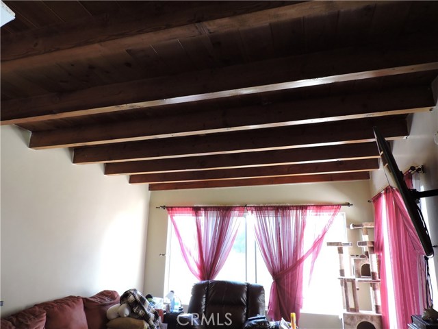 Wood paneled and beamed ceilings in back unit.