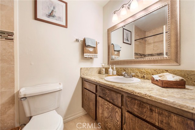 Updated bathroom with new lights, granite counters, tile shower