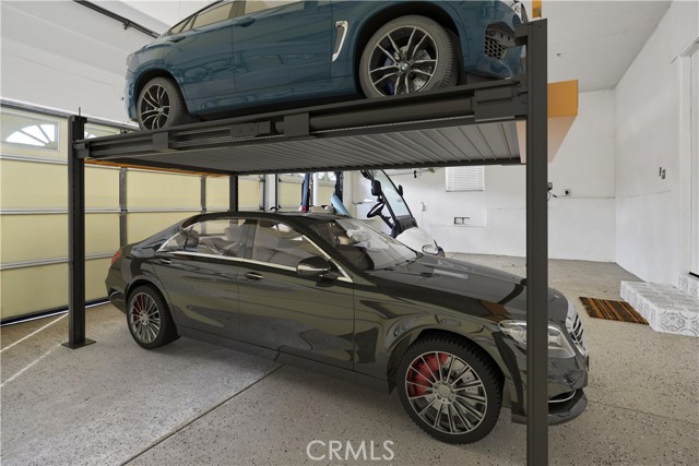 Virtually Staged- previous owner used car lift to store multiple vehicles.
