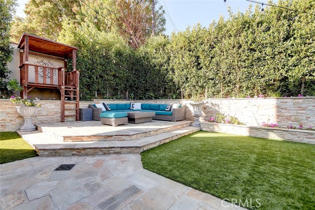 Relax at the fire pit as the kids hang in the treehouse!