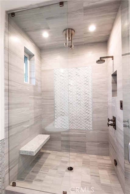 5.5’ x 3.5’ Enclosed Custom Tiled Shower with Steam, High Quality Kohler Shower Fixtures and Floating Bench.