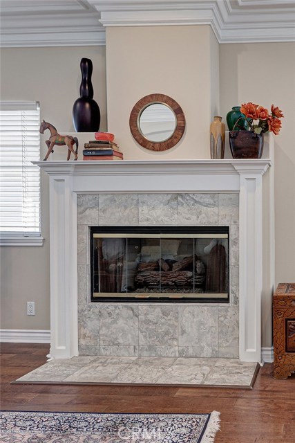 Elegant hearth/mantel frames this gas fireplace