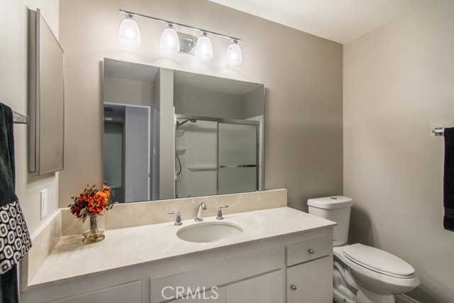 New lights, mirror, fresh paint and floors in guest bathroom