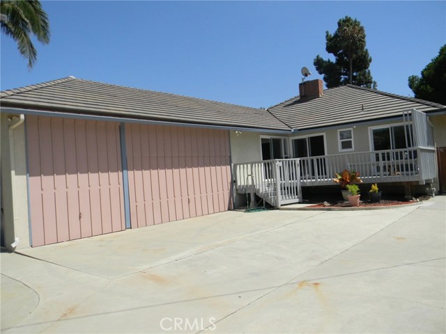 Three car garage with one oversized door for small sailboat.