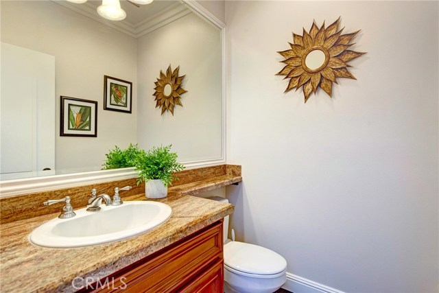 Upstairs powder room for guests with granite countertop.