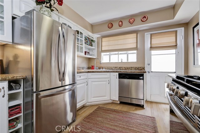 Remodeled kitchen features hardwood floors, stainless appliances and loads of cabinetry.  Easy access door opens to the east side of the home.