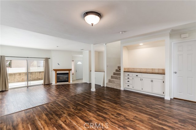 Family room with built in dry bar and storage, sliding door to patio