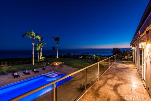 Upper level balcony views of the pool, fire pit and ocean