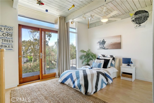 A wall of glass is featured in this bedroom.