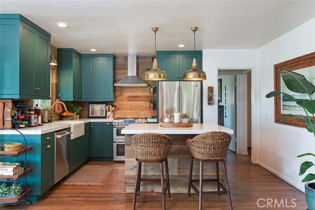 fully remodeled kitchen with top of the line cabinetry & appliances and beautiful reclaimed wood wall and island.