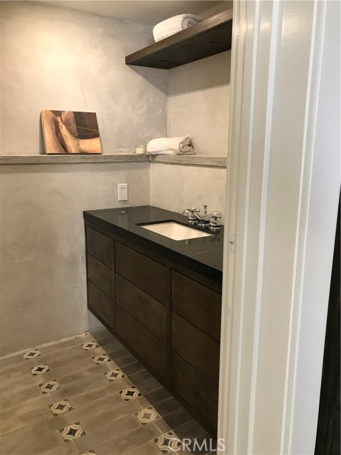 Designer bathroom with shower, made of custom tile and architectural cement