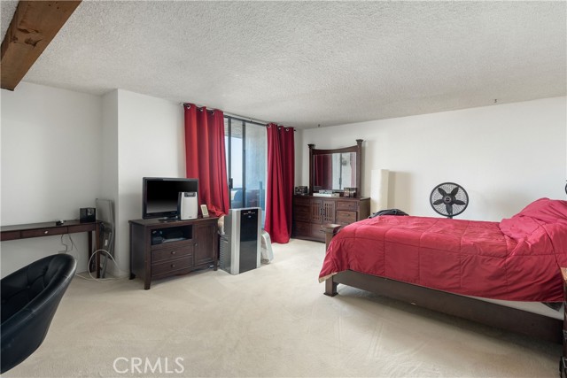 Huge master with en-suite bathroom, walk-in closet, and balcony.
