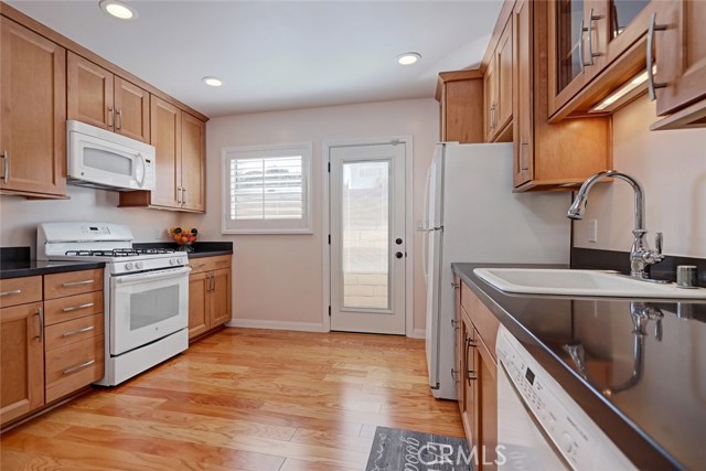 Another view of the kitchen as you enter, with the side door that take you to the yard.