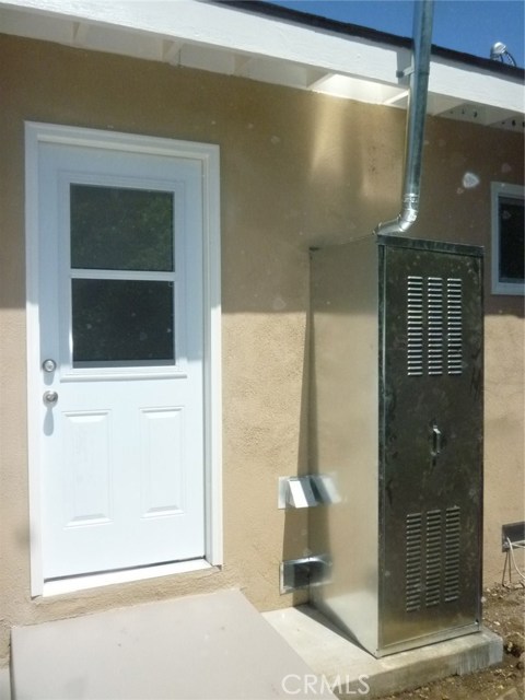 New outdoor water heater cabinet.  The door leads to the laundry area off of the kitchen.