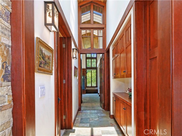 8ft. custom cherry doors to bedroom wing with skylights brightening the way.