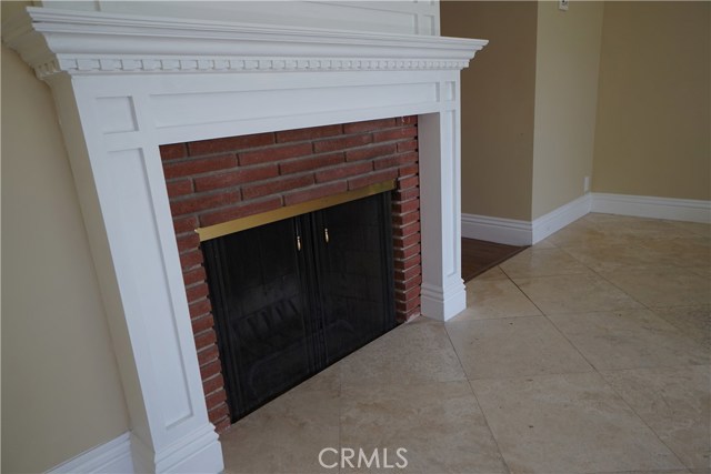 Livingroom gas fireplace and terrazzo flooring. Wood flooring in other main rooms.