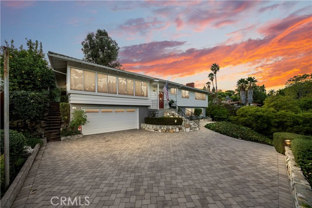 Custom driveway with pavers and room for additional parking.