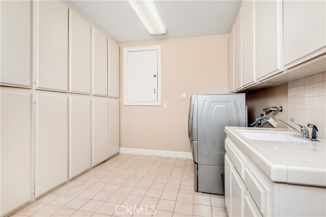 Large lower level laundry room with copious storage