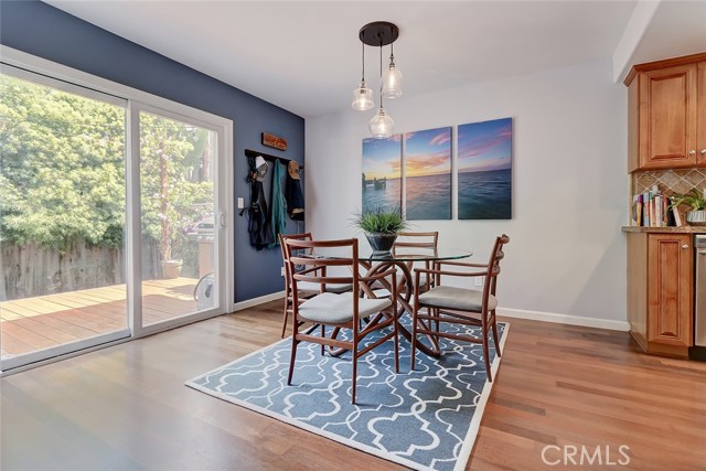 Cozy dining room adjacent to the kitchen features an updated modern light fixture.