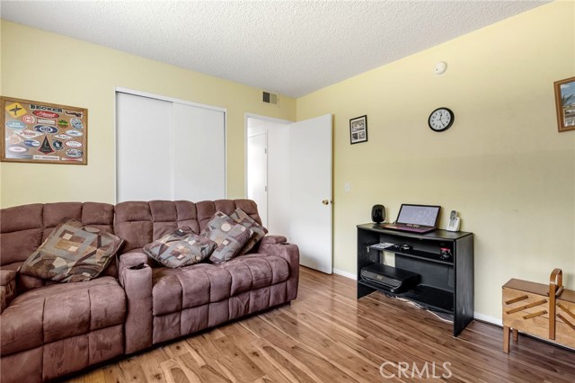 Entry level bedroom used as a den. Closet is behind couch in picture.