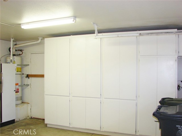 ANOTHER WALL OF CUPBOARDS FOR STORAGE. CONVENIENT SIDE DOOR TO BACKYARD PATIO AREA.