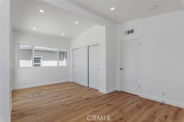 This upper bedroom has the same vaulted ceiling.