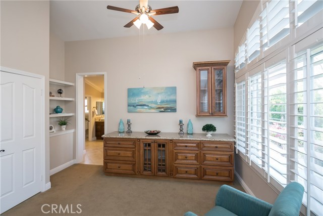 Masters bedroom sitting area with built-in entertainment center & granite countertop.