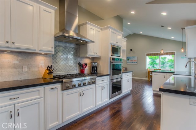 Kitchen opens to family room and eating area with breakfast bar.