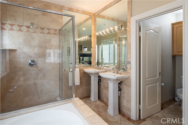 The master bathroom suite is highlighted by the elegant fireplace and features a large jetted tub, large shower, and customized walk-in closet.