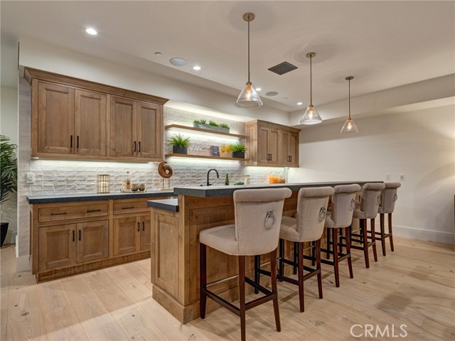 HUGE 1,557 sq. ft. entertainer's dream basement with full bar, dishwasher, ice maker, fridge, 86" TV already installed, surround sound, wired for Dolby Atmos 9.4.2 channel cinema, lounge area, half bath, downstairs bedroom suite.