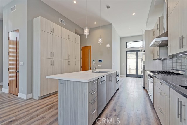 LIGHT AND BRIGHT KITCHEN.  LOOKING TOWARD THE FRONT DOOR. CENTER ISLAND.  DOUBLE SINKS.  LOTS OF COUNTERTOPS FOR COOKING..THIS HOUSE WAS MADE WITH ENTERTAINING IN MIND.