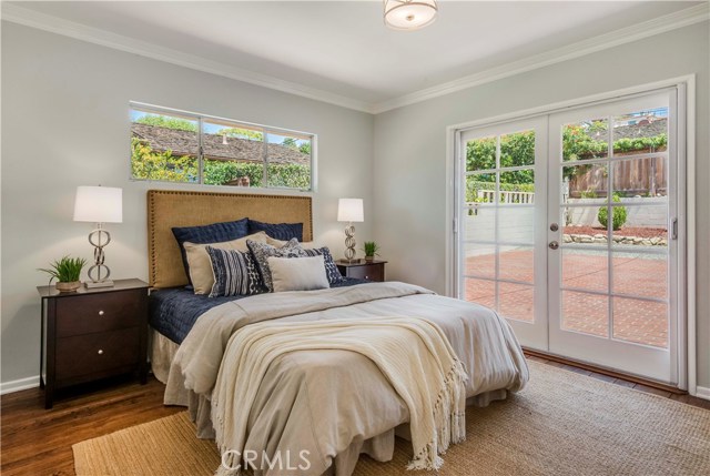 Back bedroom with French doors and hardwood floors