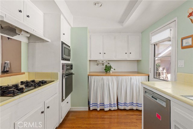 Electric Washer and Gas Dryer in Kitchen.  Door leads out to the Garage.