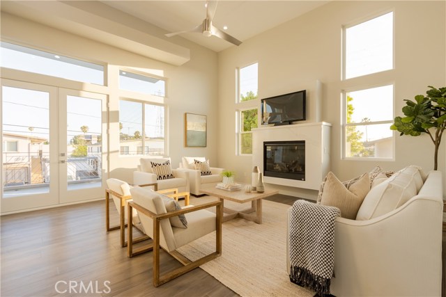 LIVING ROOM, FIREPLACE, CEILING FAN AND ACCESS TO BALCONY