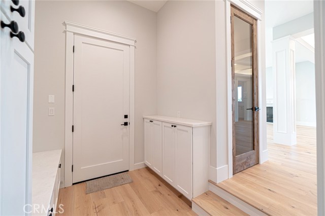 View of mud room and door to garage.  View of wine cellar on the right hand side.